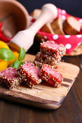 Composition of knife,    sliced salami sausage with sesame,