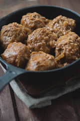 Frying pan with meatballs, vertical shot, close-up