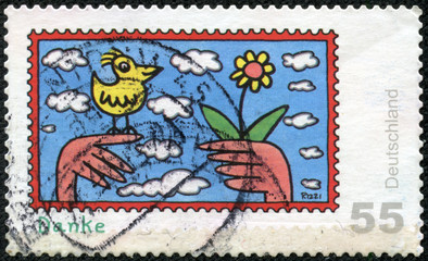 stamp showing children's drawing birds and flowers