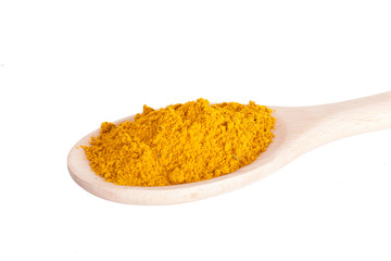 Curry seasoning in a wooden spoon, it is isolated