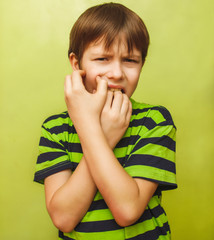 young kid child boy toothache pain in mouth, dental pain, holdin