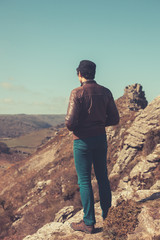 Fototapeta premium Young man standing in the mountains