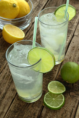 Glass with cold drink with lime and ice