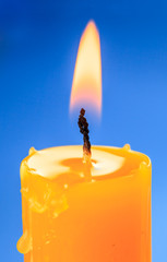Flame of candle over blue backround