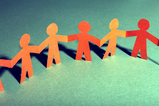 Paper team linked together partnership concept