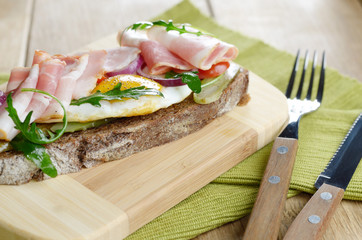 Bacon and fried eggs open sandwich