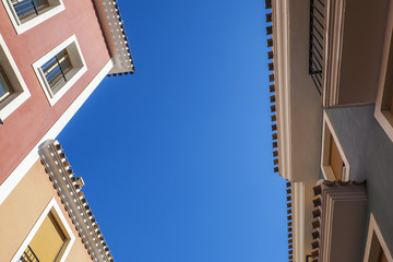 Spanish holiday apartments, pastel colours and balconies.