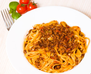 spaghetti bolognese on white plate