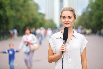 Young reporter standing in the street