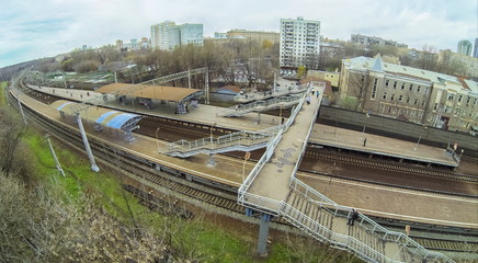 View from quadrocopter to people waiting at train at platform