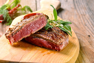 Beef steak on a wooden table.