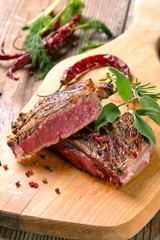 Beef steak on a wooden table.