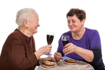 Happy mother with daughter drinking wine