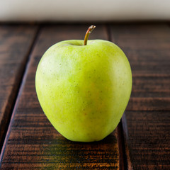 Green apple on old wood table