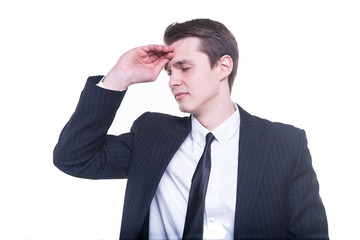 Young businessman with a big headache isolated on white