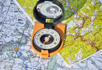 Map, compass and shadow