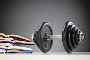 Dumbbell Next to Open Books
