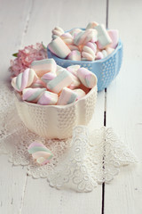 Pastel colored marshmallows in bowls, toned photo