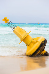 Yellow buoy on mexican beach
