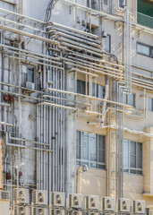 Fototapeta na wymiar Industrial pipe lines on a Building