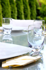 Glass table prepared for garden party