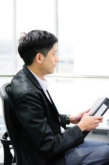 Businessman in suit with binder in hands