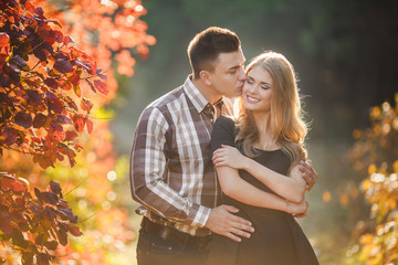 Fototapeta premium Portrait of a young couple in autumn Park 