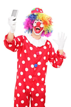 Male clown taking a selfie and gesturing with hand