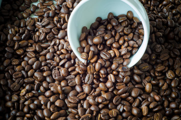 white cup with coffee beans