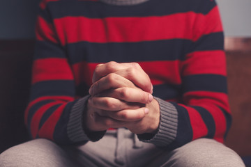 Man with hands folded in prayer