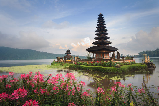 Pura Ulun Danu temple with pink flowers, Bali, Indonesia