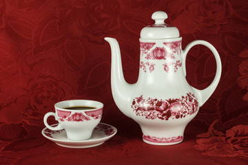 Elegant coffee set against the background of the red tablecloths
