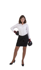 Young businesswoman with boxing gloves ready for conflict