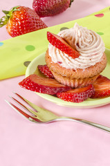 Strawberry cupcake decorated with slices strawberries