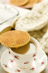 Syrup waffle on teacup showing tea