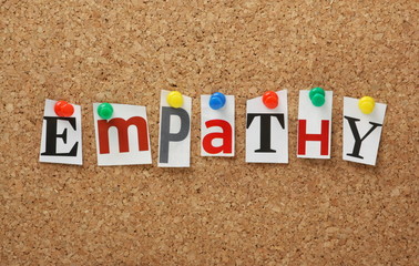 The word Empathy on a cork notice board