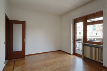 Empty room in normal apartment with wooden floor