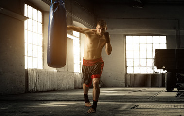 Young man boxing workout in an old building - 64179331