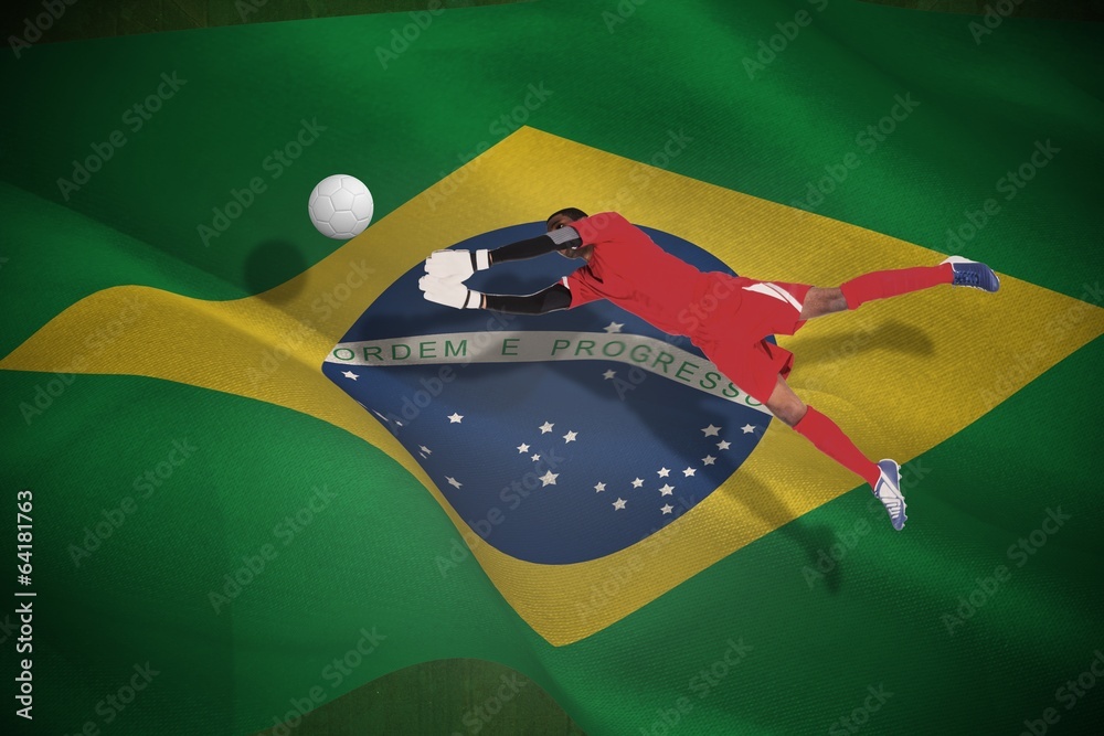 Aufkleber Composite image of goalkeeper in red making a save