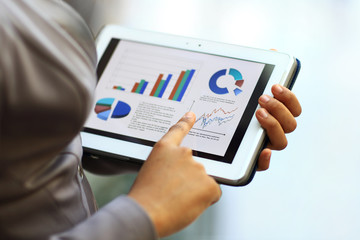 Close-up of businesswoman using tablet computer
