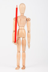 Small wood mannequin standing with colour pencil isolated on whi