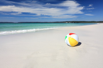 Colourful beach ball on the seashore by the ocean