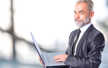 Businessman using his laptopt in the office