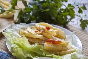 French fries on plate on wooden table