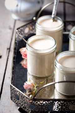 Greek yogurt in glass jars on a metal vintage tray