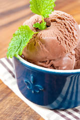 Chocolate ice-cream with mint leaf in porcelain bowl