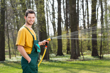 Gardener watering garden