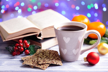 Composition of book with cup of coffee and Christmas