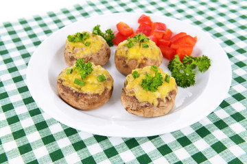 Stuffed mushrooms on plate on table close-up