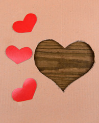 Cardboard heart on wooden background